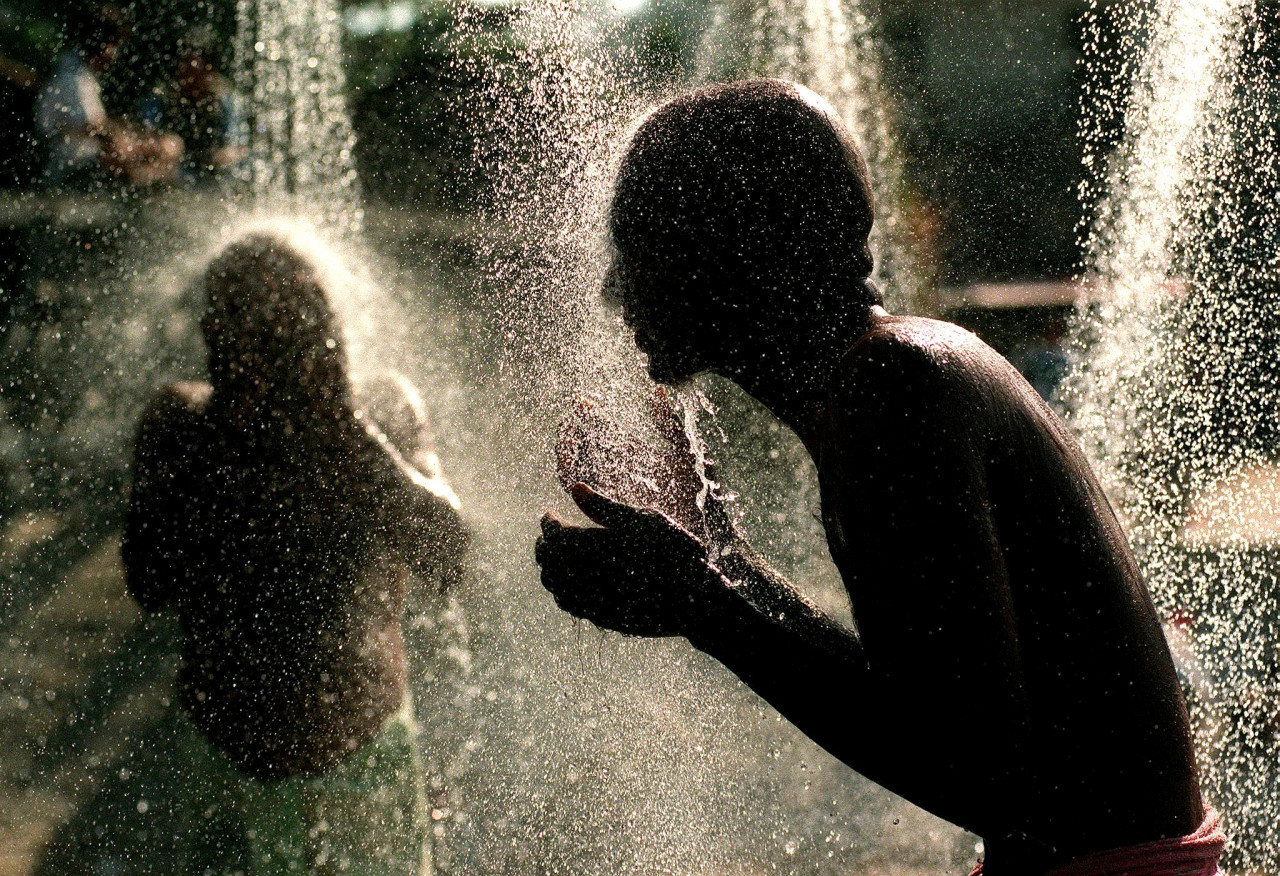 Devotees clean their body before starting the ritual piercing of their flesh with hooks or spikes as they climb up the cave's 272 steps to show penitence in Batu Caves during Thaipusam in Kuala Lumpur on January 28, 2002. – AFP pic