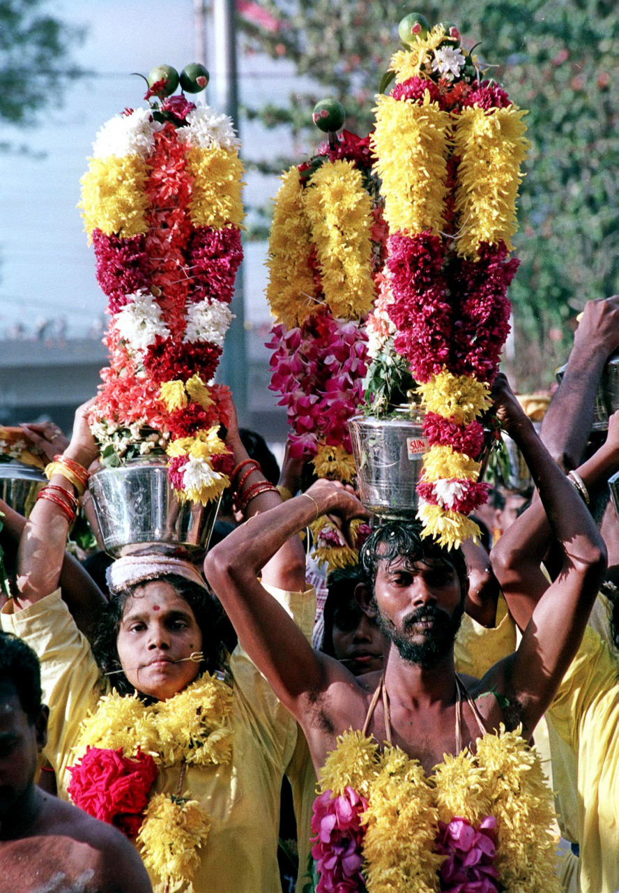 Devotees carry decorated pots which contain milk on their arrival at the Batu Caves Hindu temple on January 21, 2000. – AFP pic