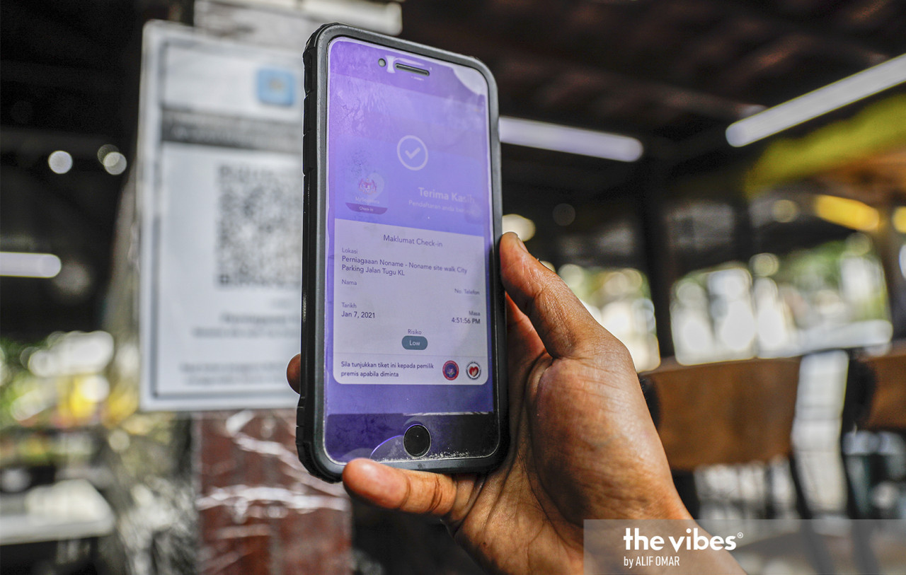 Scanning a QR code through MySejahtera is now part of everyone's daily routing. - ALIF OMAR/ The Vibes pic