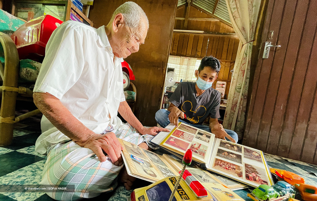 Hashim Rejab (L) and Liang Kok Hwa pass the time together as they look over old toys and photo albums. – SOFIA NASIR/ The Vibes pic