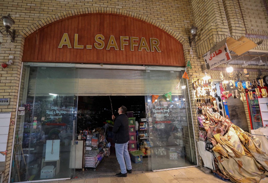 An Iraqi man opens his shop in the old bazaar in Arbil on February 10, 2021. – AFP pic
