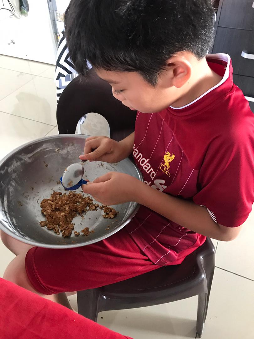  Armand prepares the confectionary in his family's kitchen. - Pic by Nina Othman