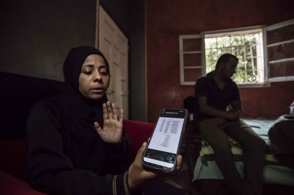 Egyptian veterinarian Walaa Fathi shows the name list of 17 Egyptians who went missing in Libya while trying to get to Europe, on September 23, 2020. – AFP pic, October 5, 2020