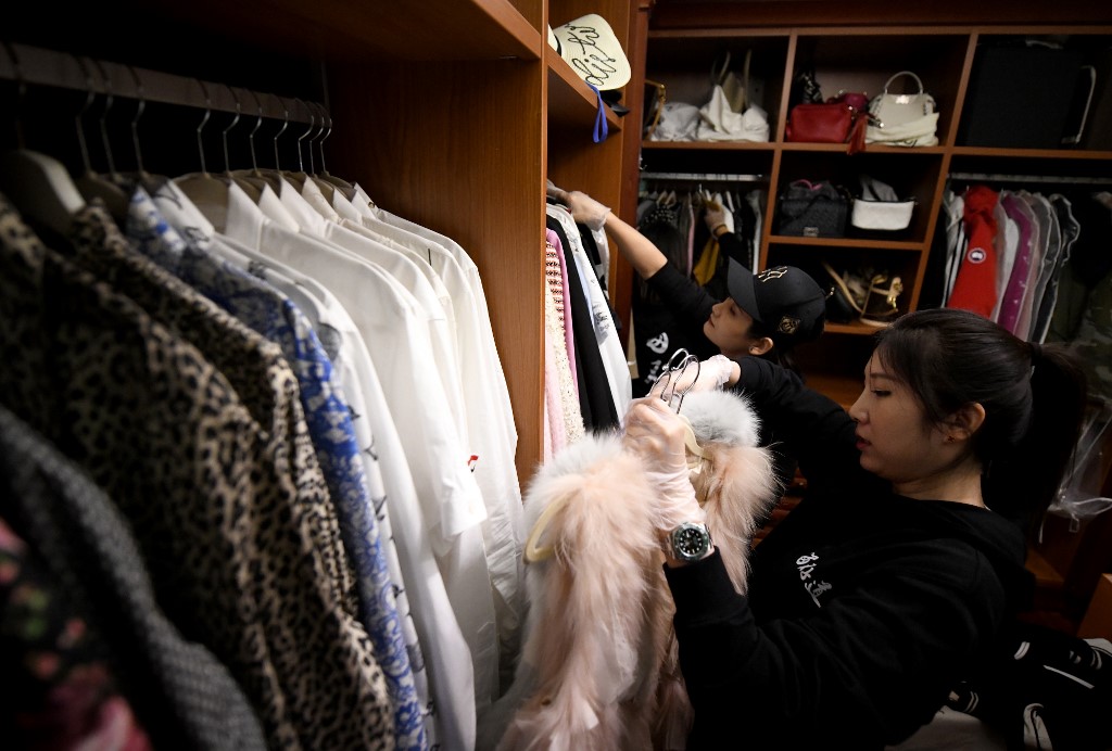 Home organisers arranging the luxury wardrobe of client Chen Rui in Beijing. – AFP pic, November 9, 2020