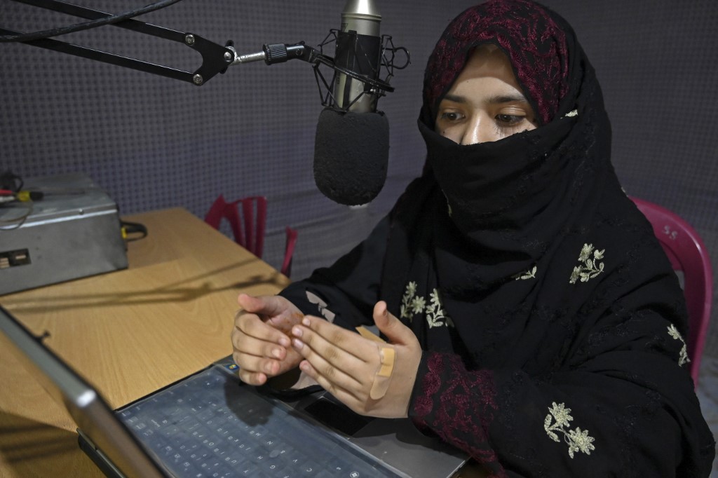 In this photo taken on September 29, 2020, radio presenter Shukria Wali, 18, reads the news during a broadcast at the Merman radio station in Kandahar. – AFP pic
