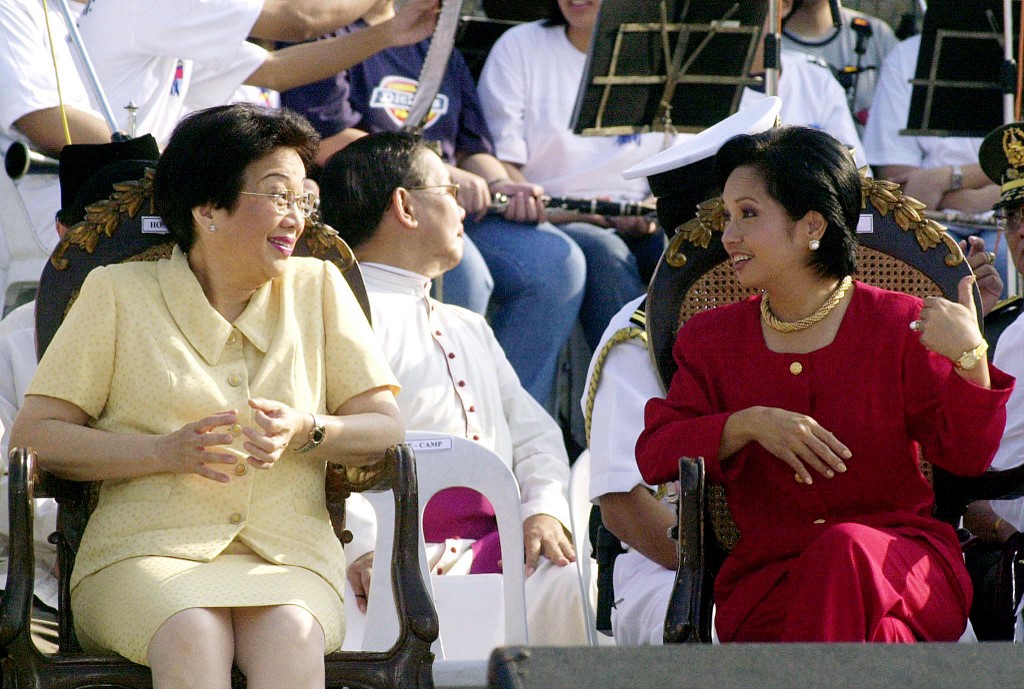 Former Philippine presidents Corazon Aquino (left) and Gloria Arroyo share a light moment at a ceremony marking the 15th anniversary of an uprising that toppled dictator Ferdinand Marcos’ regime, in Manila in February 2001. – AFP pic, September 21, 2020