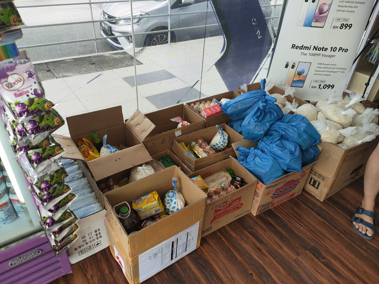 Members of the public leave their donations at phone accessories shop H Tag’s food bank. – REBECCA CHONG/The Vibes pic, July 10, 2021