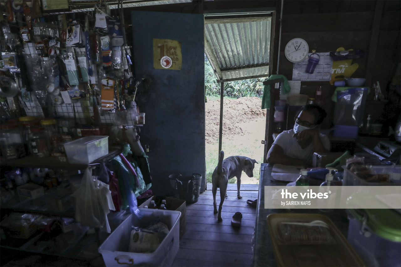 A shop owner, accompanied by her dog, at Kampung Poturidong in Kiulu. - The Vibes pic, Oct 1, 2020