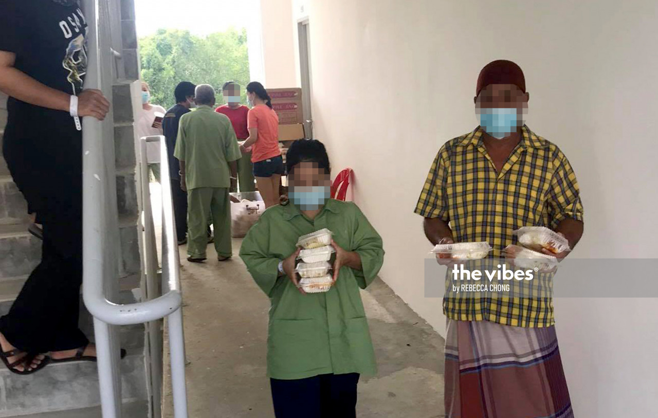 Covid-19 patients in Block F, after collecting their lunch on October 12, 2020. – REBECCA CHONG/October 13, 2020