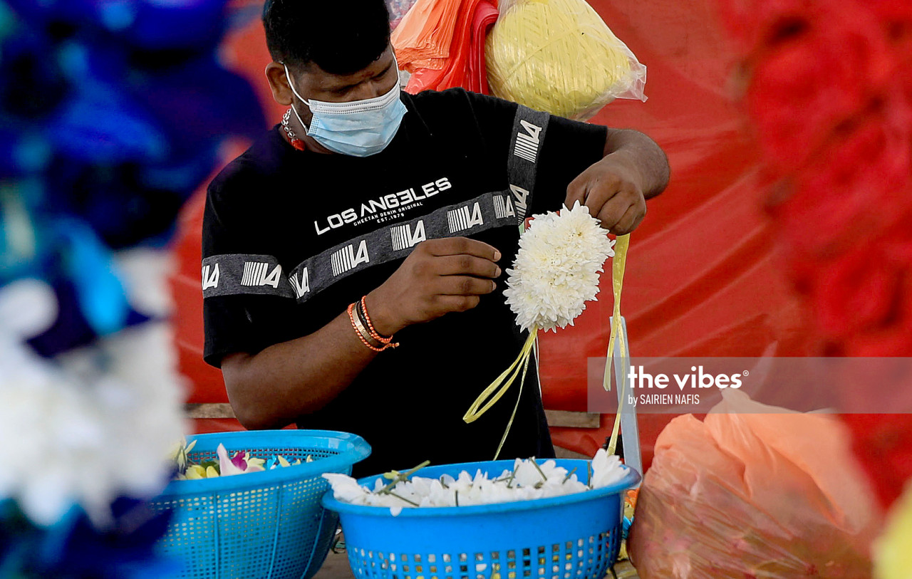 A florist preparing a garland outside a temple. – The Vibes pic, November 14, 2020