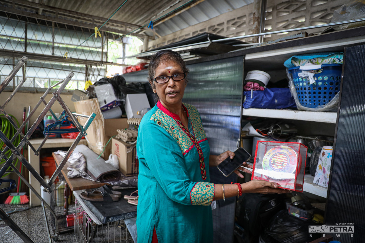 Taman Sri Muda resident Bhanumathy Narayana, 62, says years worth of photographs and baby clothes – which she had stored away from the days when her children used to wear them – were damaged. – SYEDA IMRAN/The Vibes pic, May 19, 2022