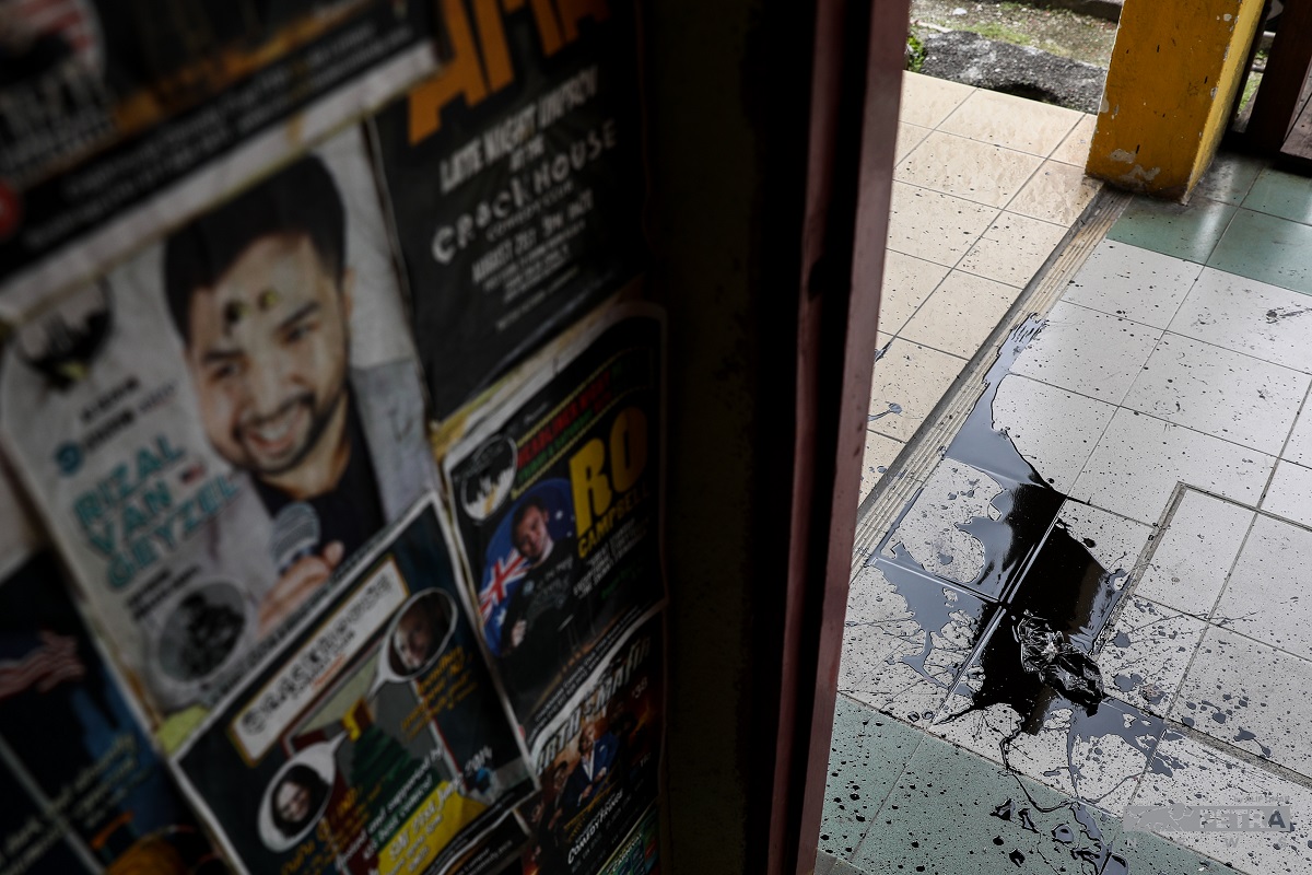 Black paint splatter the ground floor entrance of the comedy club can be seen, as well as more posters that were vandalised. – ALIF OMAR/The Vibes pic, July 19, 2022