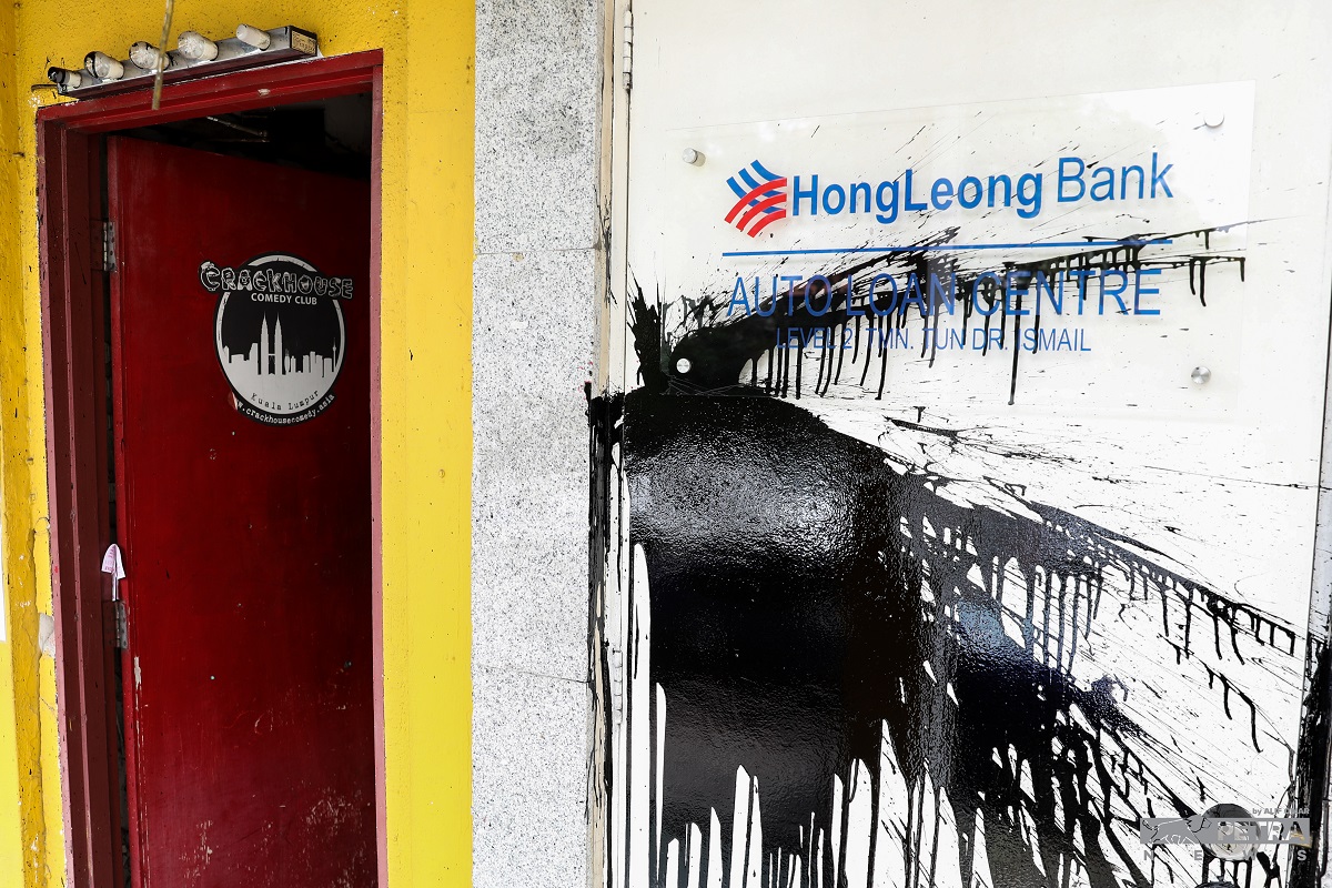 Parts of the Hong Leong Bank outlet on the ground floor next door were also splashed with black paint. – ALIF OMAR/The Vibes pic, July 19, 2022