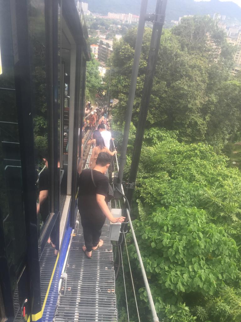 Passengers of the funicular train that broke down midway in Penang Hill, are escorted to safety by officers from the Paya Terubong fire and rescue department, on October 3, 2020. – IAN MCINTYRE/The Vibes, October 3, 2020