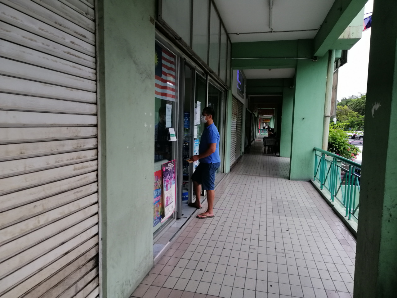 A man buying some groceries from in front of a shop in Kota Kinabalu. – The Vibes pic, October 3, 2020