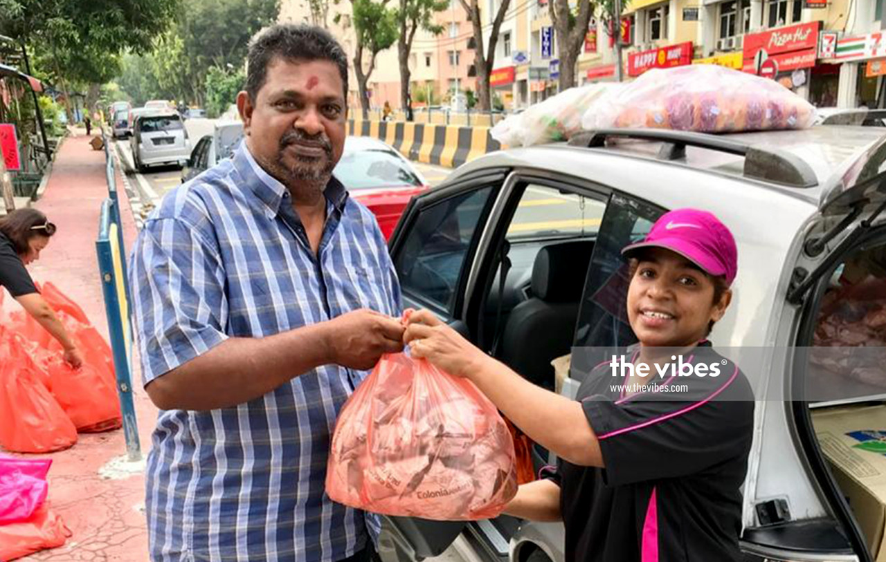 Jeeny De Kujiper (right) and a happy recipient of food being distributed to needy families in George Town. – Pic courtesy of Jeeny De Kujiper, December 19, 2020