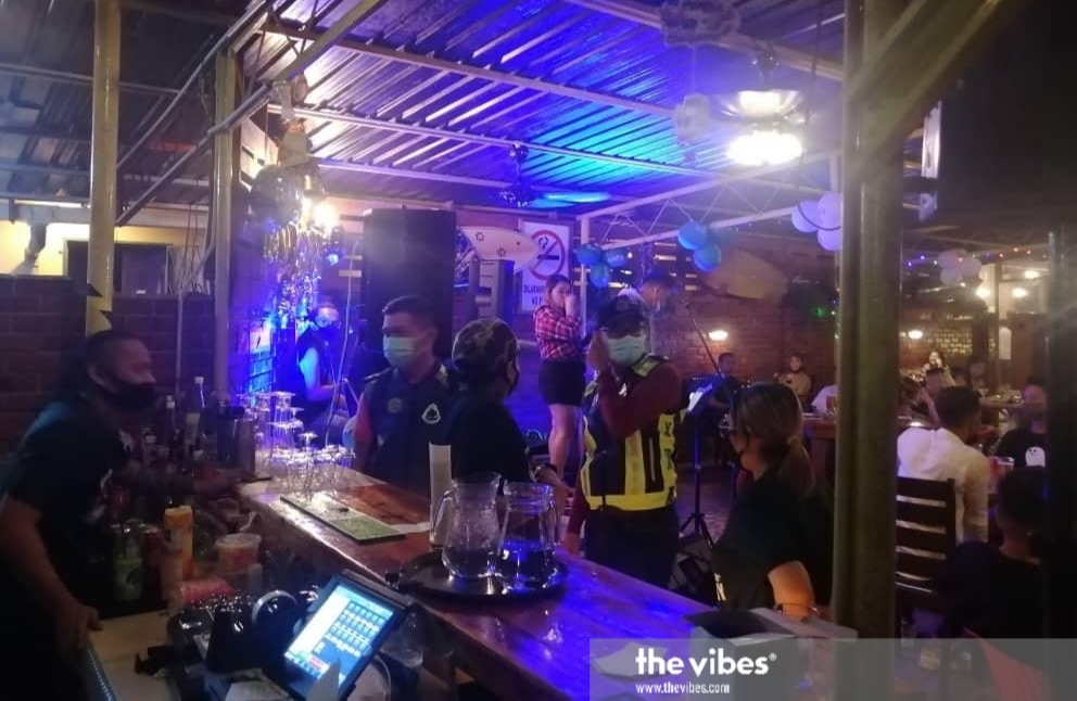 Labuan police check visitors at a pub in the state which flouted the conditional movement control order. – Pic courtesy of the police, January 1, 2021 