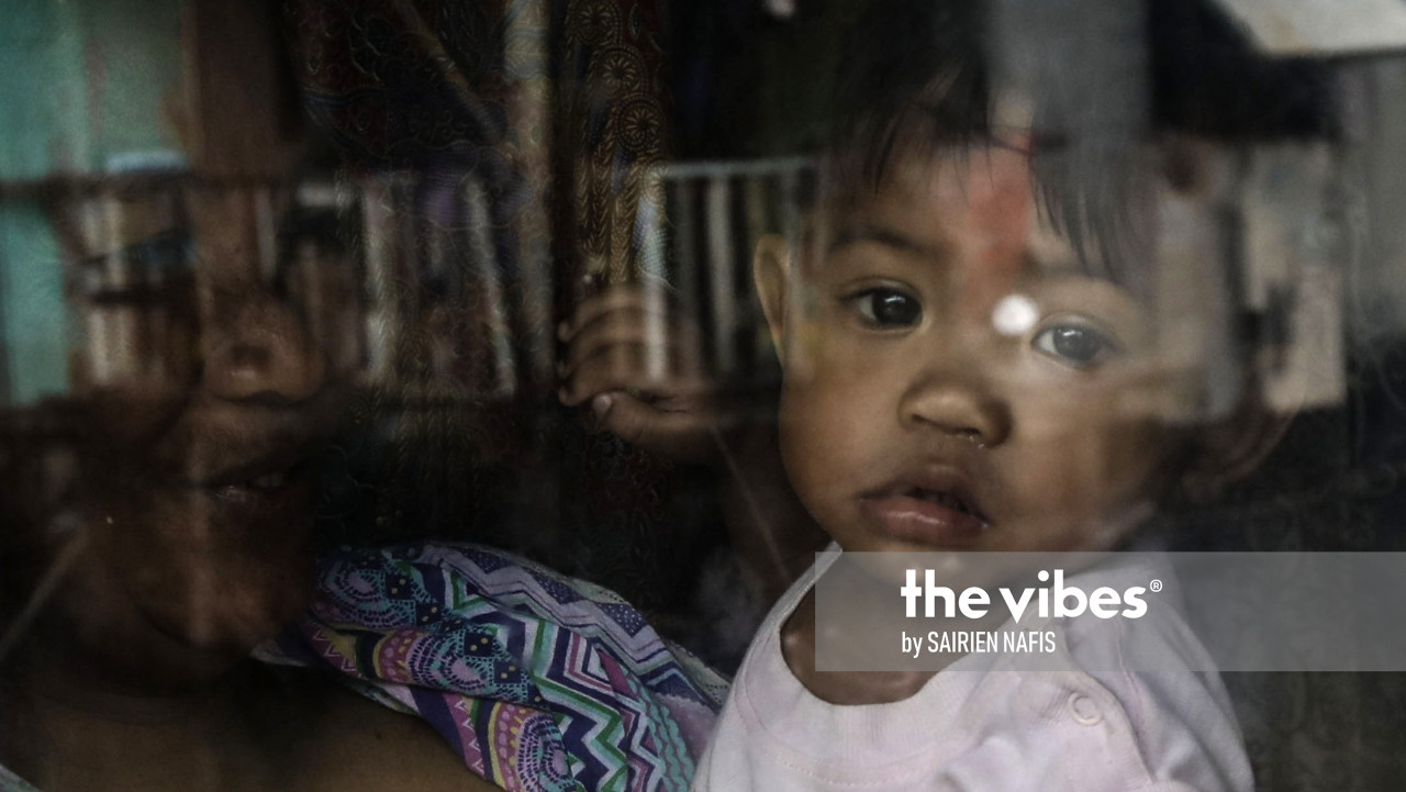 A child looks out the window of a house in Kg Numbak. – The Vibes pic, September 24, 2020