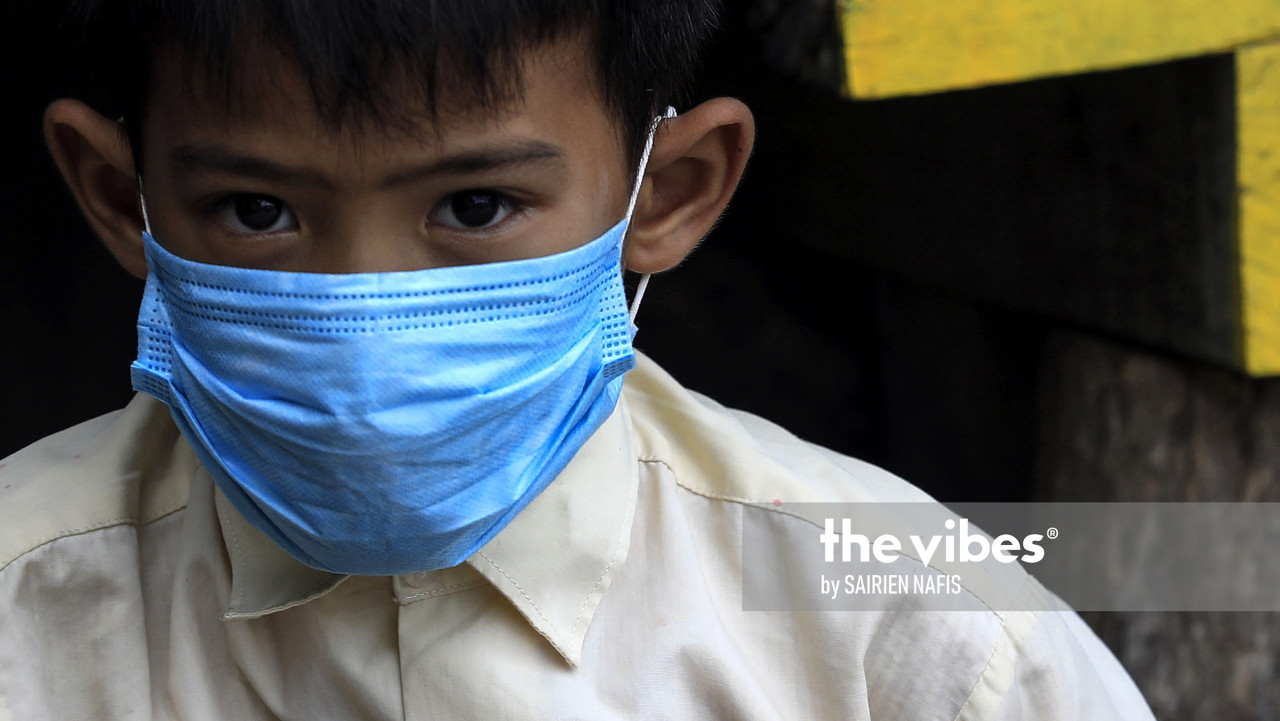 A boy in a mask seen in Kg Numbak. – The Vibes pic, September 24, 2020