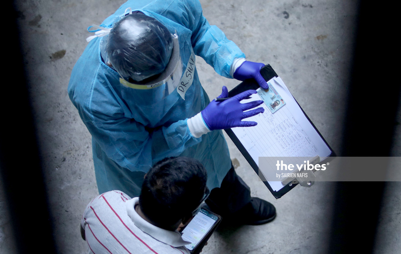 Petaling health officers at the Pelangi apartment in Damansara conducting swab test - The Vibes