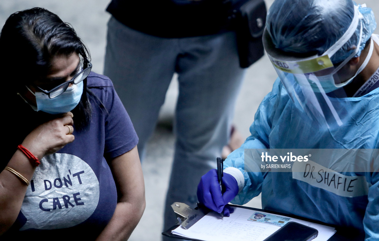 Petaling health officers at the Pelangi apartment in Damansara conducting swab test - The Vibes
