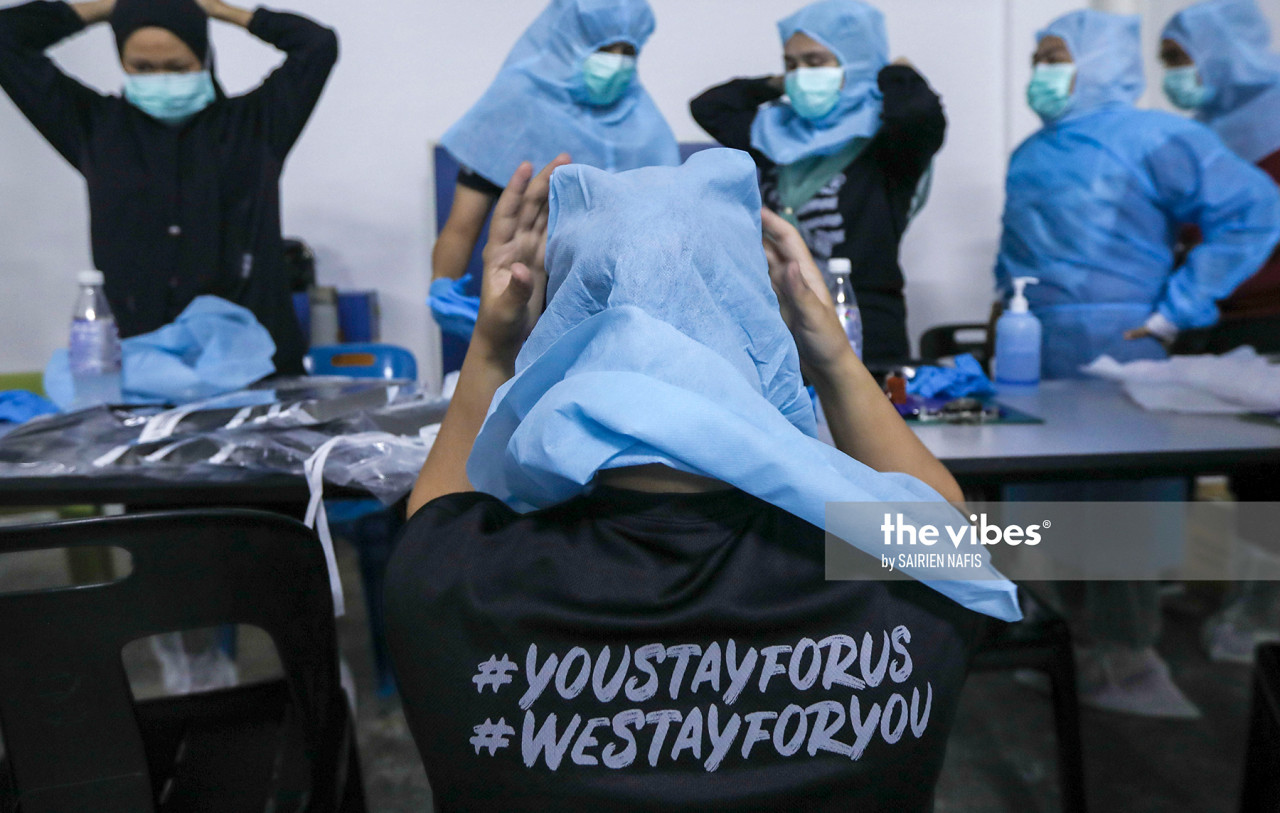 Petaling health officers at the Pelangi apartment in Damansara conducting swab test - The Vibes