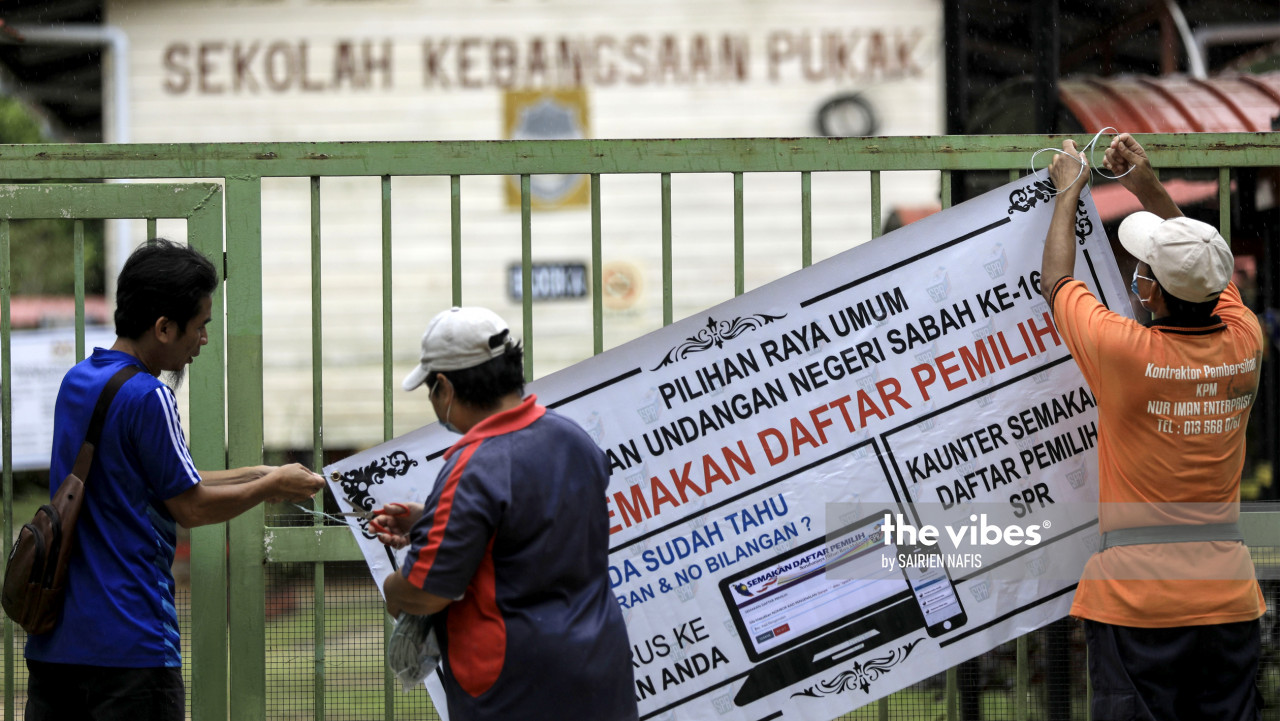 A banner being affixed to the gates of SK Pukak, which will serve as a polling station tomorrow. – The Vibes pic, September 25, 2020