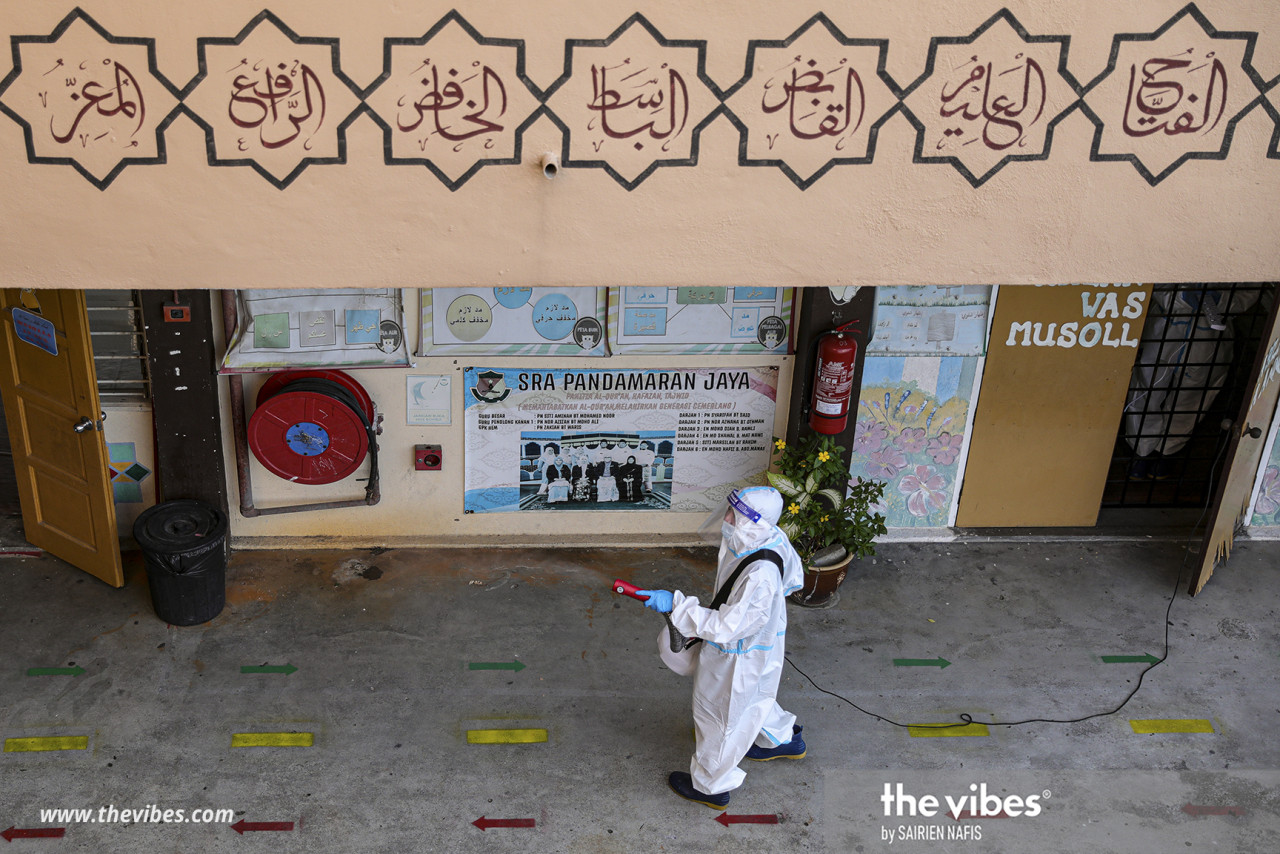 A worker is seen sanitising the area in front of classrooms at SRA Pandamaran Jaya in Klang, Selangor, in preparation for the reopening of schools. – SAIRIEN NAFIS/The Vibes pic, February 28, 2021