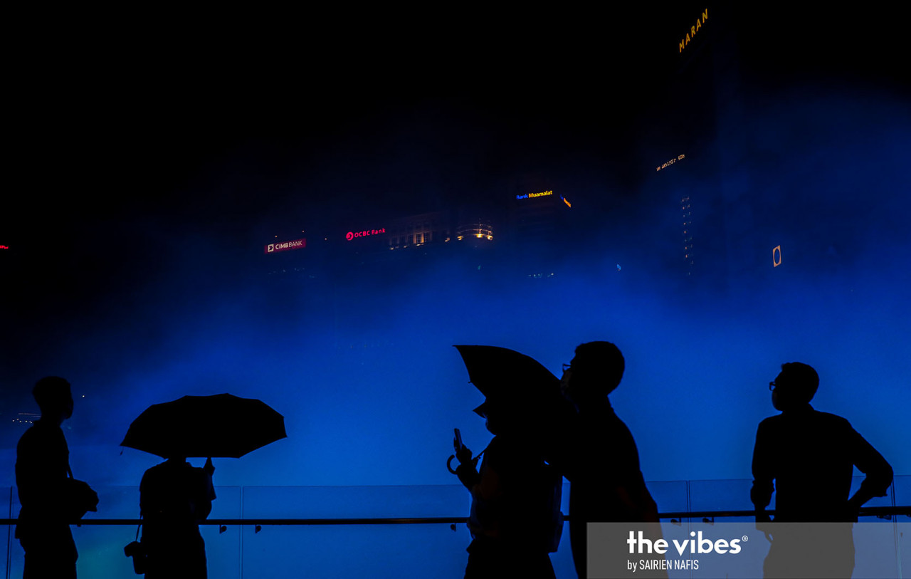 Passersby stopping to take in the atmosphere at KL's River of Life on the last day of 2020. – The Vibes pic, January 1, 2021
