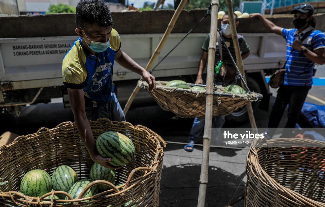 A seller weighing watermelons at the Pasar Besar in Kota Kinabalu. - The Vibes pic, Oct 1, 2020