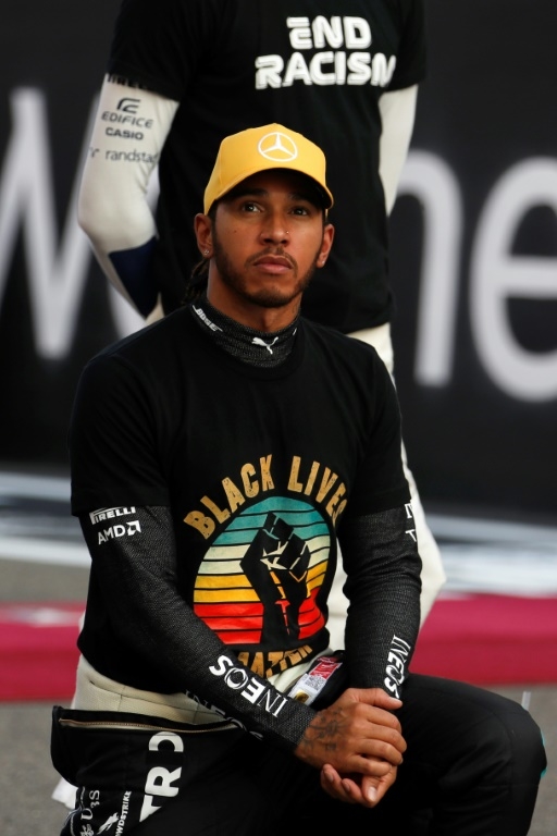 Taking the knee, and a new record: Mercedes' British Formula One driver Lewis Hamilton. – AFP pic