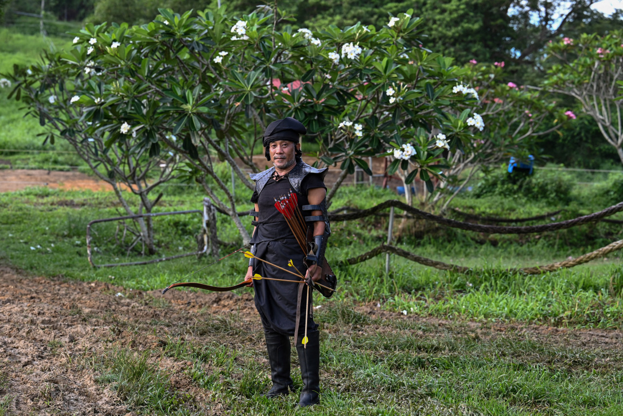 Zaharudin Rastam Yeop Mahidin (pictured above) wearing traditional headgear during a Horseback Archery League competition at Cape Cavallho Equestrian Club in Rembau on November 13. – AFP pic, November 29, 2021