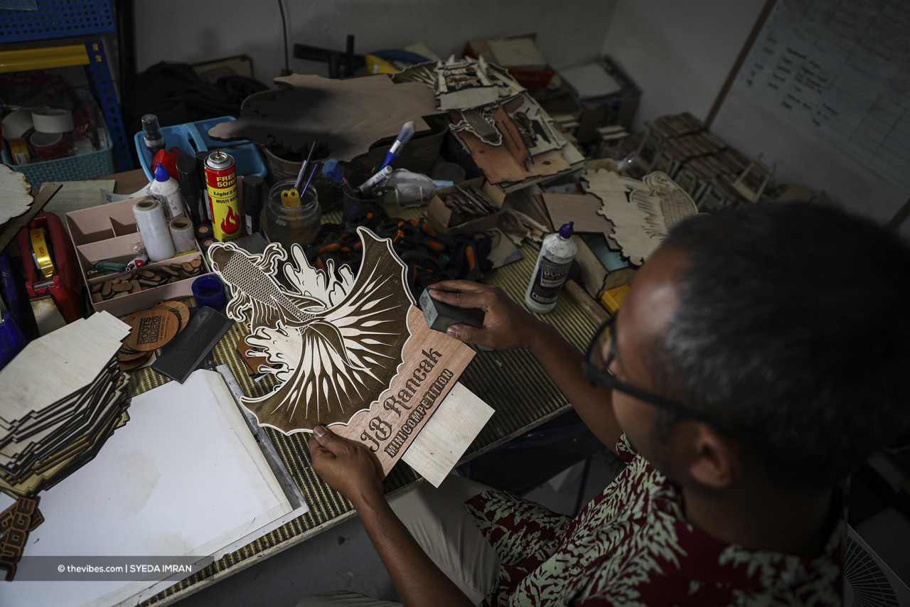 Ashraff working on laser cut wood designed for his clients. – SYEDA IMRAN/The Vibes pic