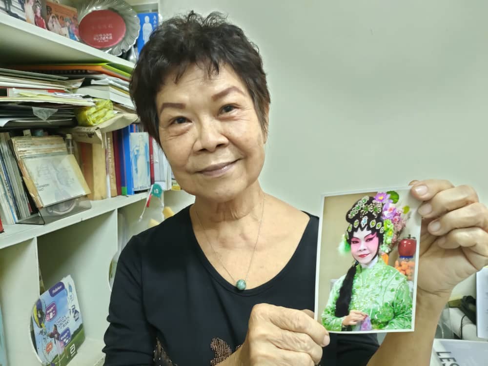 Dr Sin Sun Moi, 73, showing a picture of her with full make-up for performance when she was younger. – Rebecca Chong pic