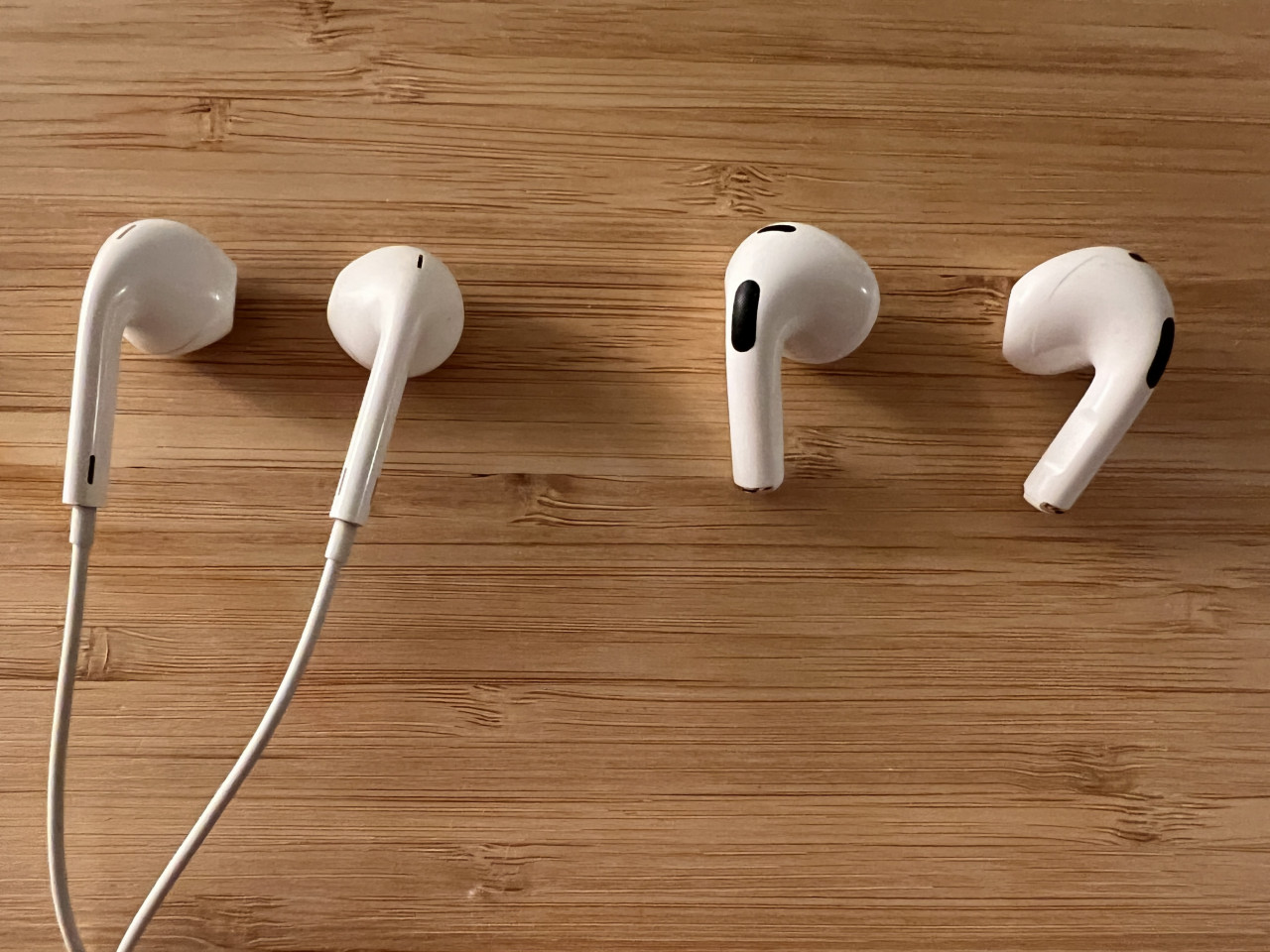 A size comparison between some old Apple earbuds and the new AirPods. – Haikal Fernandez pic