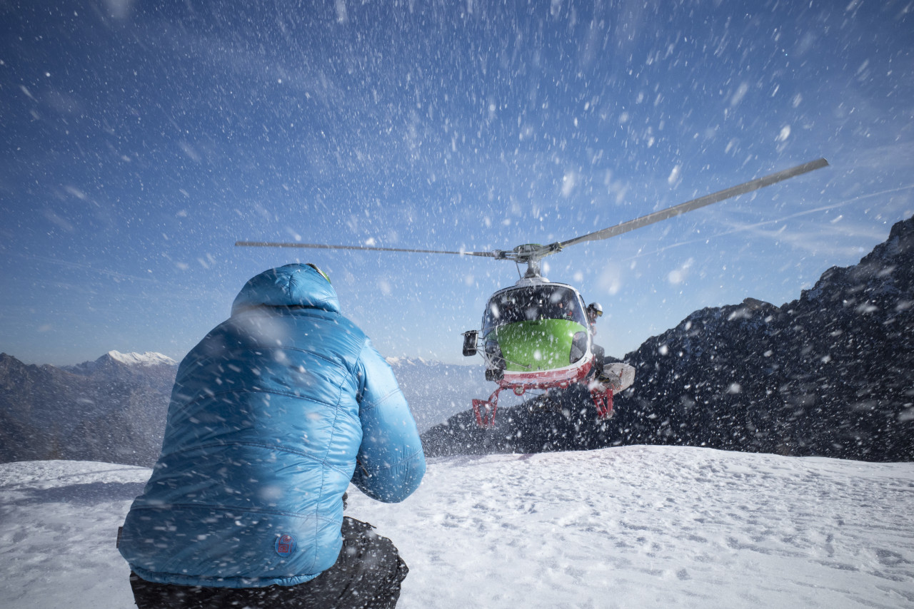 Italian speleologist Professor Francesco Suaro greeting the arrival of the helicopter carrying bio acoustician Professor Michel Andre high in the Italian Dolomites. – Pic courtesy of National Geographic for Disney+