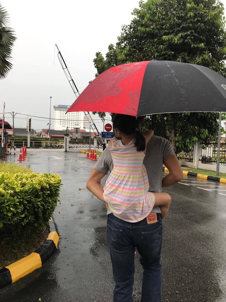Esther's daughter during a visa run at Johor’s immigration last week on rainy day. – Pic courtesy of Esther