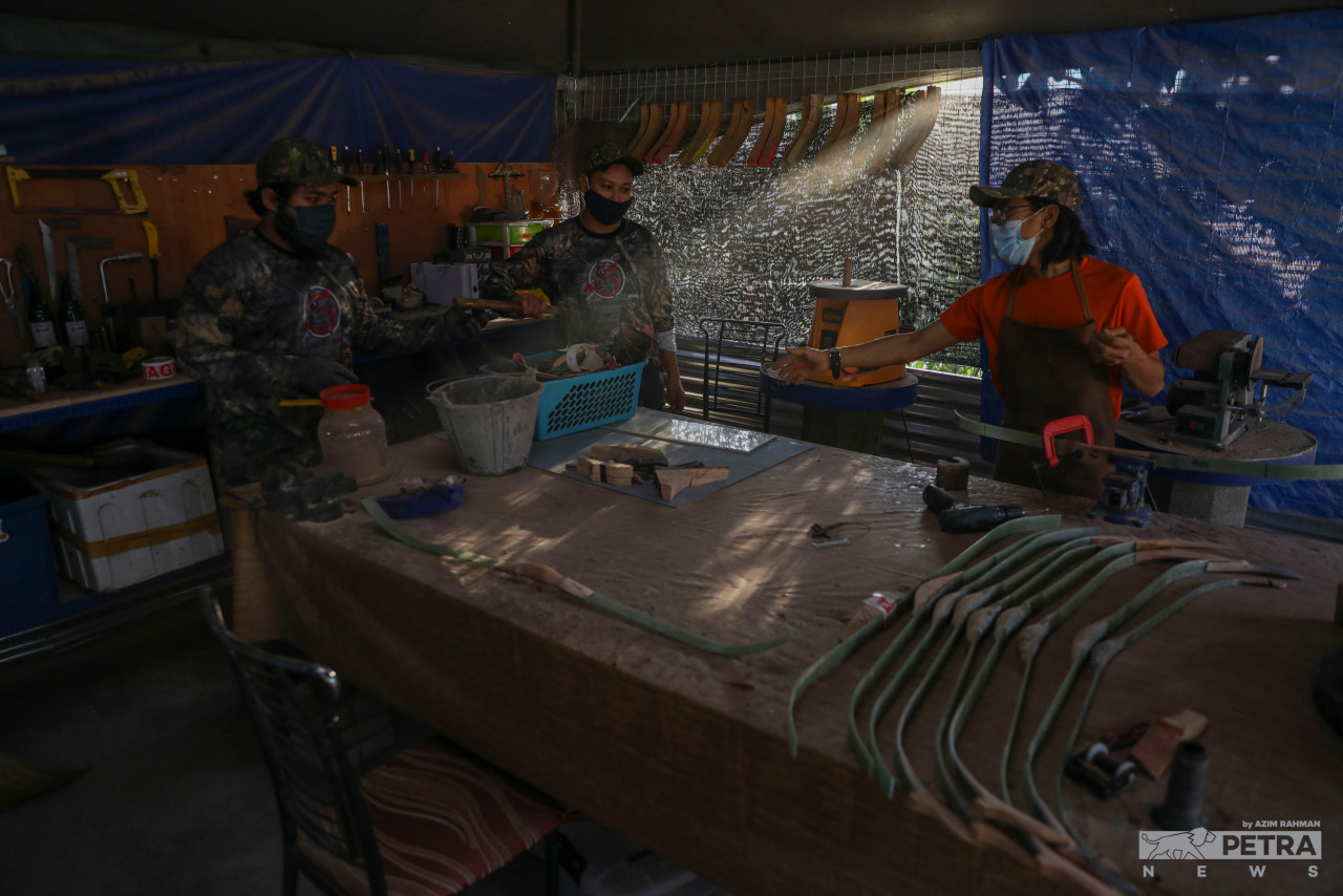 The Taming Sari Archery crew busy attending to the bows at the workshop in Durian Tunggal, Melaka. – AZIM RAHMAN/The Vibes pic