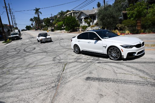 Vehicles driving over tyre skid marks from other drivers doing burnouts and 'donuts' on Bellevue Ave as area residents protest an increase in street racing takeovers and the latest Fast and Furious movie being filmed in the Angelino Heights neighbourhood of Los Angeles, California on August 26, 2022. – AFP pic