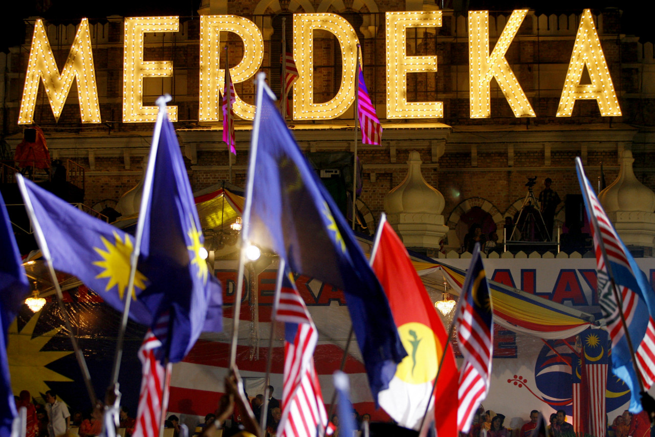 The historic Sultan Abdul Samad building is adorned with a sign that reads Merdeka (Independence) as Malaysian and component party flags of the leading National Front party are seen in the foreground, late August 30, 2007, at the historic Merdeka Square in downtown Kuala Lumpur in anticipation of Malaysia's 50th independence anniversary at the stroke of midnight on August 31. – AFP pic