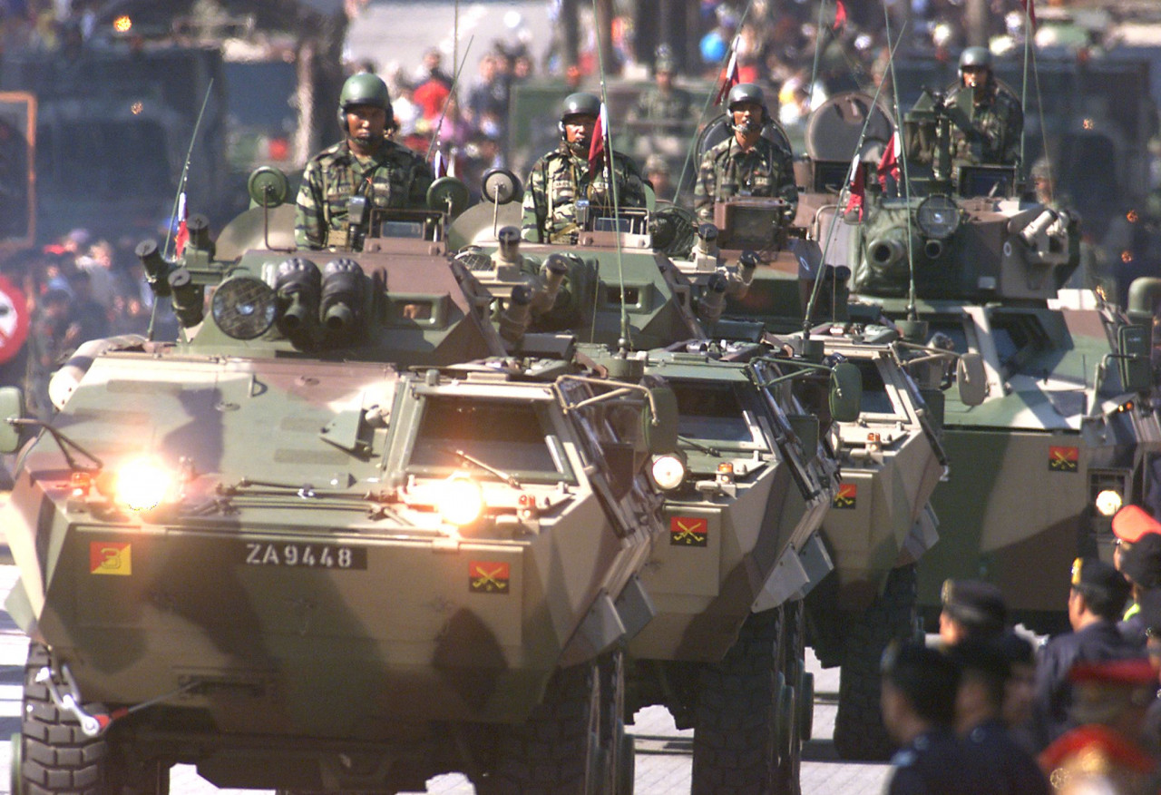 Malaysian armoured vehicles take part in a parade at Kuala Lumpur's Merdeka Square August 31, 1999. – AFP pic