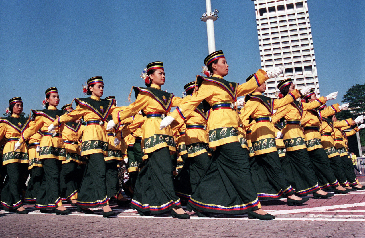 Participants dressed in their corporate colours marching along Merdeka Square during National Day celebrations in Kuala Lumpur on August 31, 1999. – AFP pic