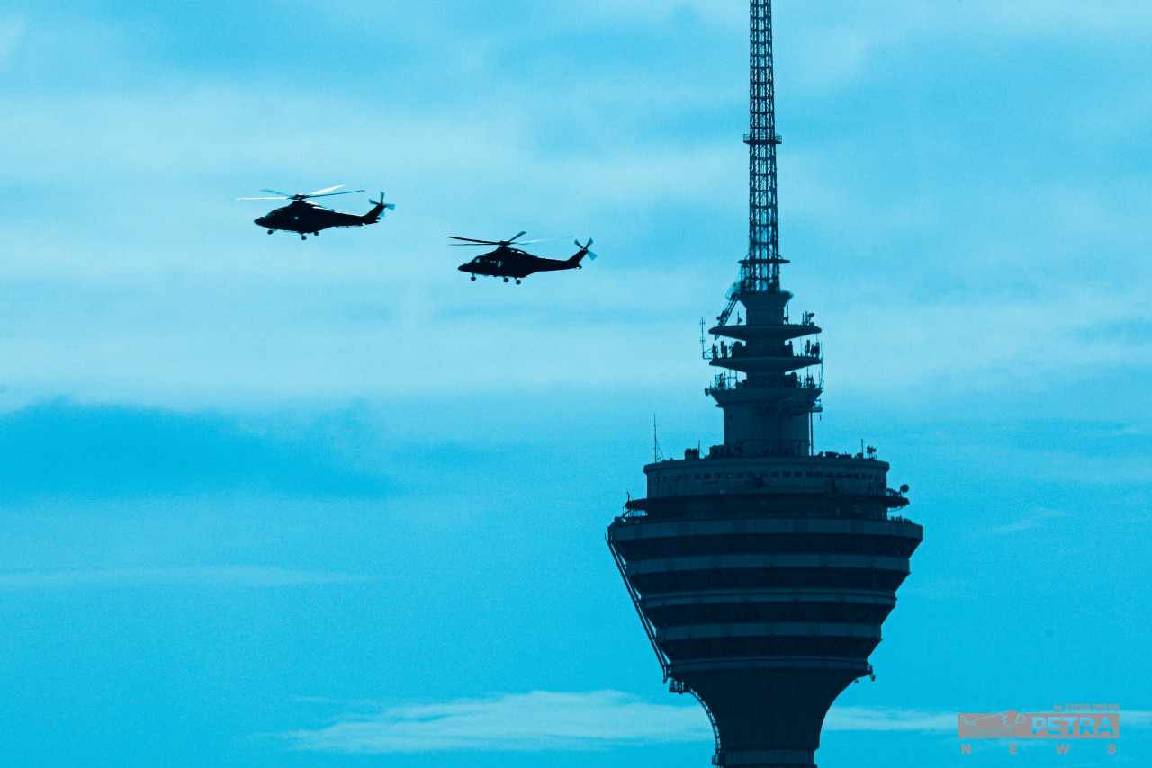 Helicopters whiz past the Kuala Lumpur Tower towards Dataran Merdeka for a fly-by. – SYEDA IMRAN/The Vibes pic, August 30, 2022