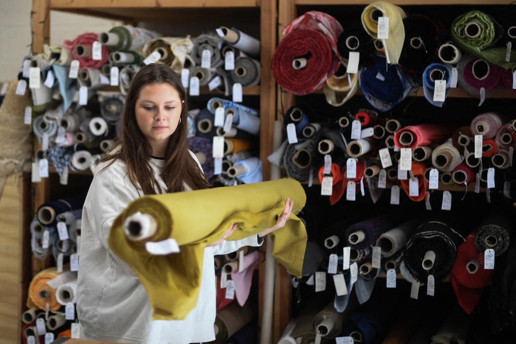 Molly picking up a roll of fabric at The New Craft House in Hackney, East London on February 11, 2022. – AFP pic