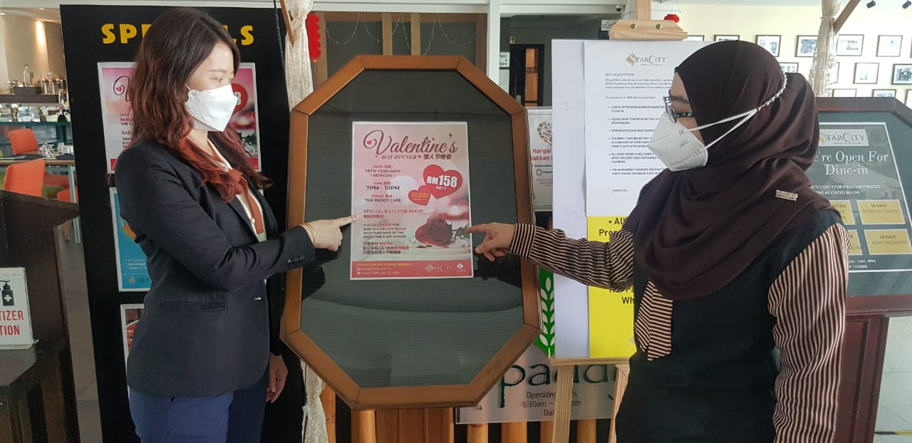 Justlyn Lai, the Star City Hotel sales and marketing manager with her colleague, Bazrina Ismail, who is the human resources department manager, showing the Valentine's Day specials. – Ian McIntyre pic
