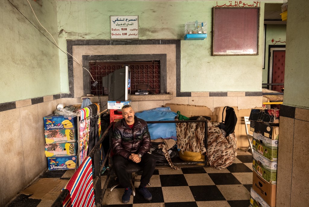 A man sitting between boxes piled up at the entrance of the 'Al Malaki' cinema, located in the heart of the market in the working-class neighbourhood of Derb Sultan, in the western Moroccan city of Casablanca, on January 24, 2022. – AFP pic