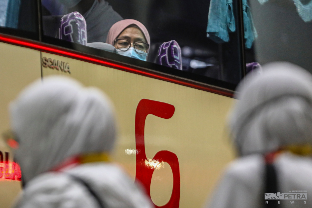 The gloomy faces of the pilgrims who will be separated from their loved ones temporarily as they board the bus heading to KLIA. – AZIM RAHMAN/The Vibes pic, July 5, 2022