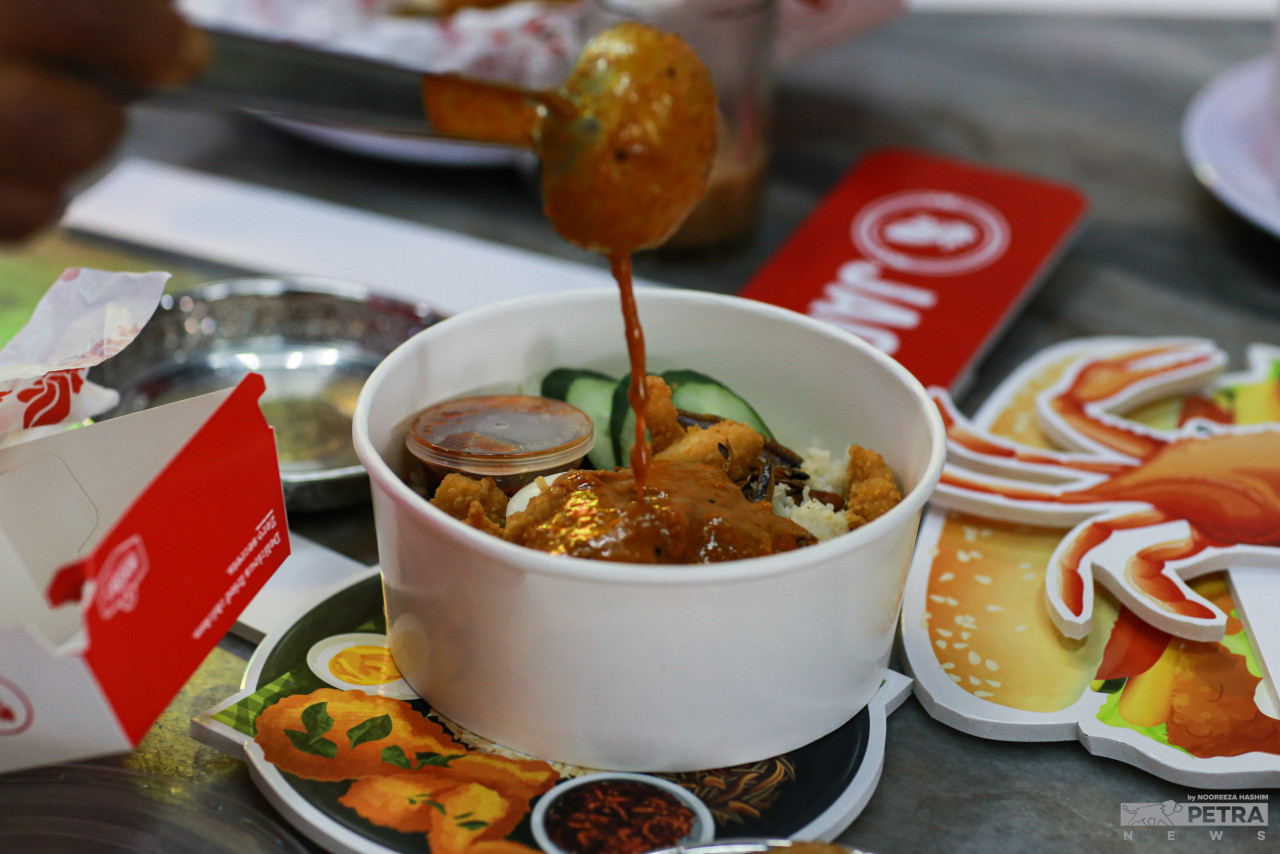 Tambahlah’s Nasi Lemak with popcorn chicken with Devi's Corner Crab Curry. – NOOREEZA HASHIM/The Vibes pic