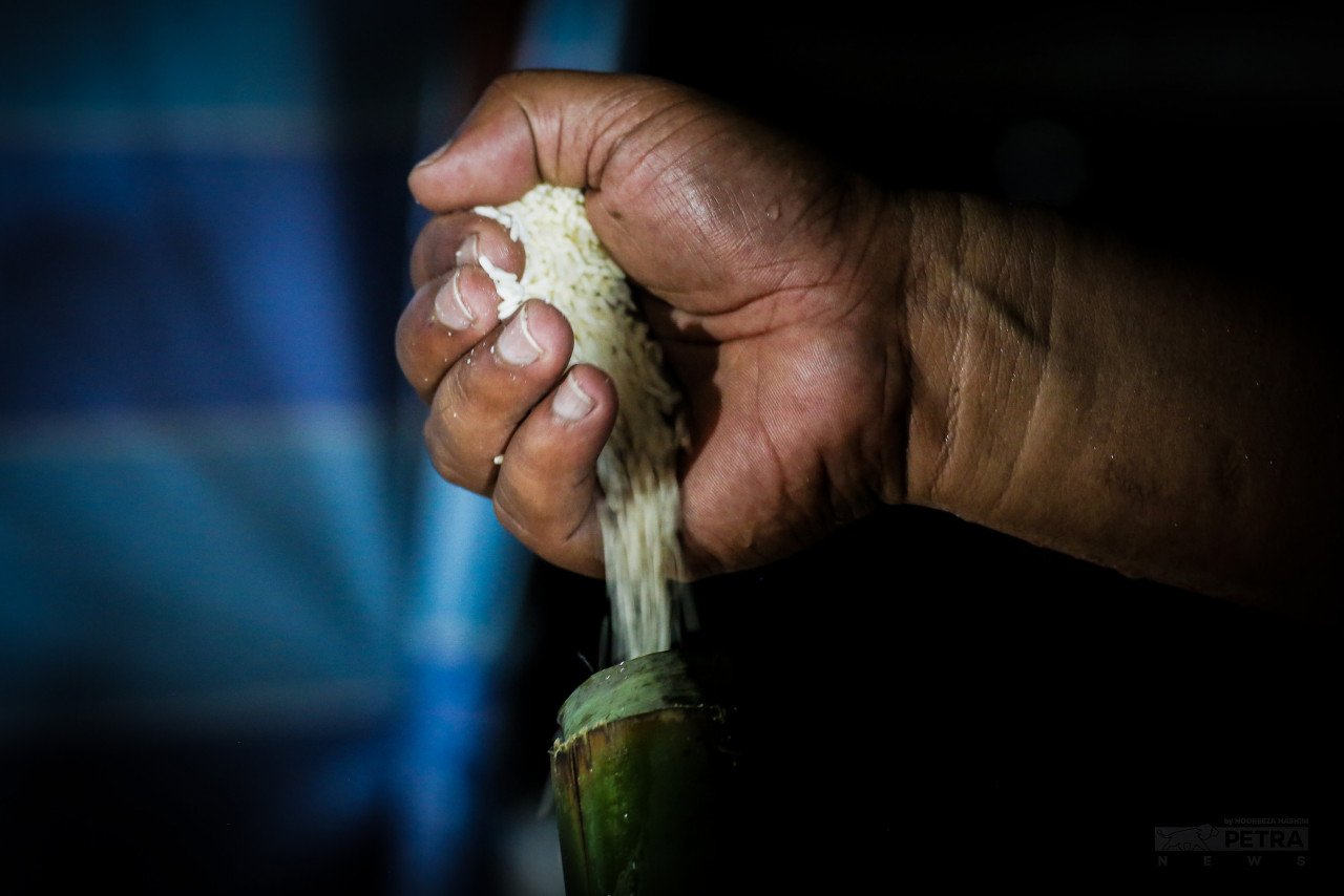 The process of grilling lemang is preceded by inserting glutinous rice into bamboo sticks. – NOOREEZA HASHIM/The Vibes pic, May 9, 2022
