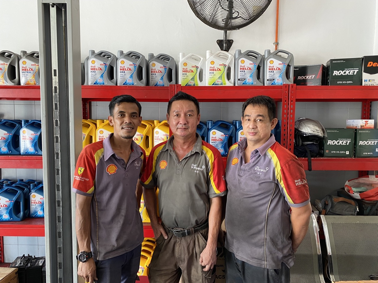 Yap and his conscientious mechanics in front of the products shelf. –  Pic courtesy of Hardip Singh Rekhraj and Abelyn Oh Ying